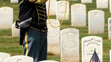 Retired Col. Sam Young plays Taps at Leavenworth Cemetery for Fort Larned soldiers who died 1859-1878