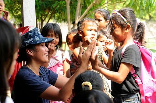 U.S. Navy electrician's mate teaches Indonesian girls a clapping game, 2012