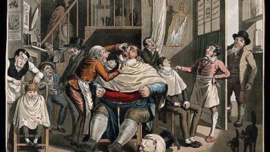 Wellcome Images, A barber cuts a man's face while shaving, Coloured aquatint